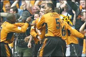 Mark Kennedy is mobbed by his ecstatic team-mates