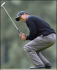 Tiger Woods is frustrated as a putt slips by on the third green