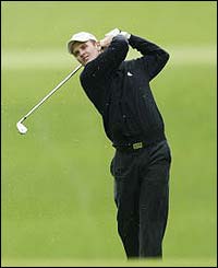 Englishman Justin Rose plays off the fairway at the second hole