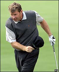 Nick Faldo reacts after playing his second shot at the par five second hole