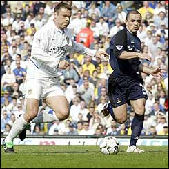 Mark Viduka evades the challenge of Spurs' Steve Carr to score the opening goal at Elland Road