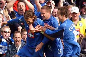 Christophe Dugarry is mobbed by team-mates after scoring against Sunderland