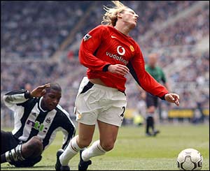 Newcastle's Titus Bramble fouls Manchester United's Diego Forlan in the box