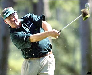Darren Clarke takes a divot as he hits the ball