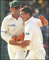 Brad Hogg and Adam Gilchrist celebrate the dismissal of Lara 
