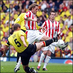 Southampton's Anders Svensson and Watford's Neil Cox tussle for the ball