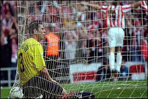Watford's Paul Robinson sits dejectedly in the back of the net after scoring an own goal