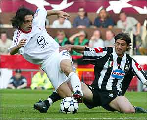 AC Milan's Andrea Pirlo, left, is tackled by Juventus' Alessio Tacchinardi 