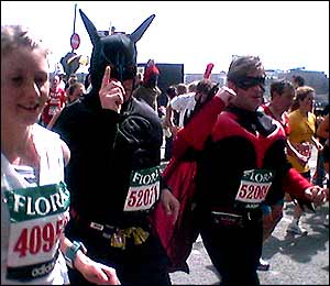 Fun runners dressed as Batman and Robin salute the crowd