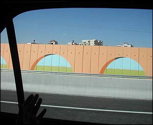 Painted 'sniper wall' separating the town of Bir Nabala from bypass road used by Jewish settlers