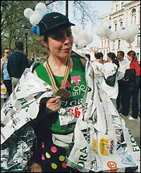 A charity runner poses with her medal