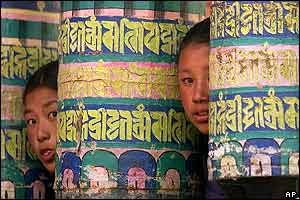Peeping between Buddhist prayer wheels at Tyang Boche monastery where some celebrations were held