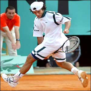 Sebastien Grosjean hits the ball between his legs