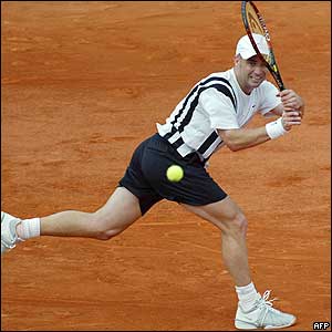 Andre Agassi hits a backhand to his Belgian opponent Xavier Malisse