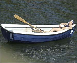 A woman relaxes on the Serpentine in London's Hyde Park