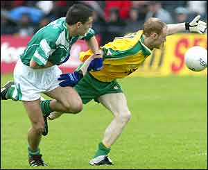Donegal's John McCafferty (right) is tackled by by Fermanagh's Ryan McCluskey