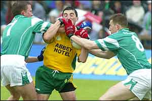 Michael Hegarty tackled by Shane McDermott and Paul Brewster 