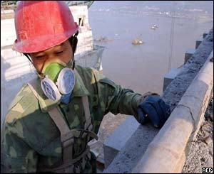 A worker puts the final touches on a sluice gate 