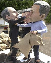 Protesters depicting Bush, Chirac and Schroeder stage a mock fight over cheap subsidised products to Africa