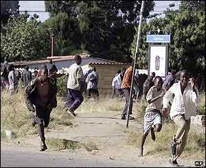 Protesters flee police tear gas