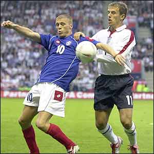 Zvonimir Vukic holds off England's Phil Neville