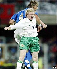 Italy's Nicola Legrottaglie and Northern Ireland's Andrew Smith jump for a header 