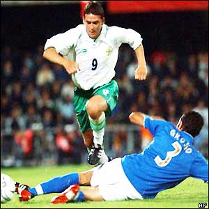 Northern Ireland's David Healy jumps over Italy's Fabio Grosso 