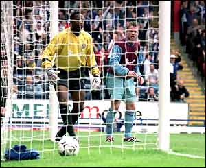 Shaka Hislop picks the ball out of the net after the seventh goal goes in