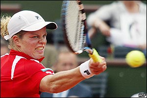 Belgium's Kim Clijsters grimaces as she hits a forehand