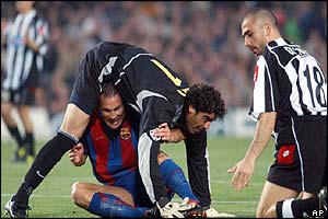 Barcelona's Patrik Andersson tangles with his goalkeeper Roberto Bonano while Juventus' Marco Di Vaio looks on