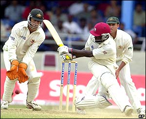 Wavell Hinds is watched by Australia wicket keeper Adam Gilchrist and Matthew Hayden as he hits a shot