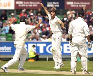 England celebrate another wicket next ball for Johnson (centre)