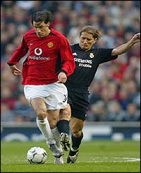 Manchester United's Ruud Van Nistelrooy battles with Real Madrid's Michel Salgado