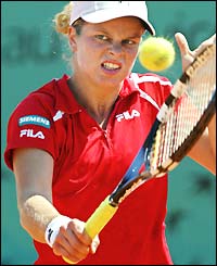 Kim Clijsters grimaces as she hits a backhand
