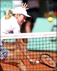 Justine Henin-Hardenne plays a delicate volley at the net