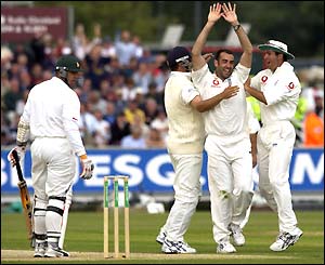 Heath Streak turns to see Richard Johnson celebrating with his team-mates, Robert Key and Michael Vaughan