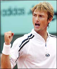 Juan Carlos Ferrero looks at the ground as he hits a backhand