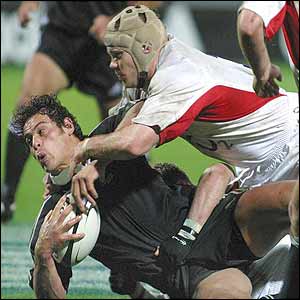 England flanker Andy Hazell tackles Ryan Nicholas