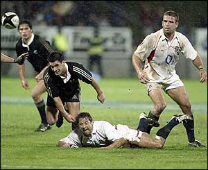 Scrum-half Andy Gomarsall manages to release a quick ball to the England backs