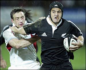 Bruce Robbins fends off England's Dan Luger