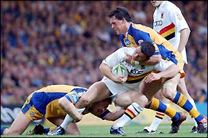 Bradford's Robbie Paul is challenged by the Leeds defence