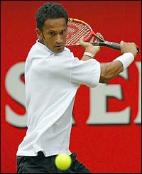 Britain's Arvind Parmar plays a backhand to Alex Bogdanovic 