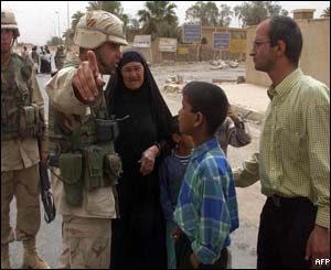 Residents of the suburb try to gain access after it was sealed off by US troops following the blast