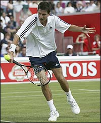 Tim Henman plays a volley at the net