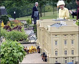 The Queen looking at a miniature model of Buckingham Palace