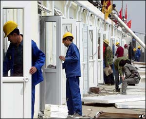 Chinese workers put together prefabricated buildings 