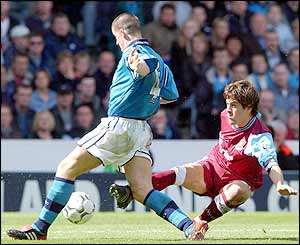 Manchester City's Joey Barton is tackled by West Ham captain Joe Cole