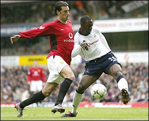 Ledley King gets the ball away from the advancing Ruud van Nistelrooy