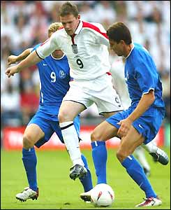 Wayne Rooney takes on the Slovakia defence