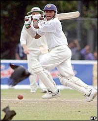 Two crows fly away as Sri Lankan batsman Hashan Tillakaratne watches the ball after playing a shot